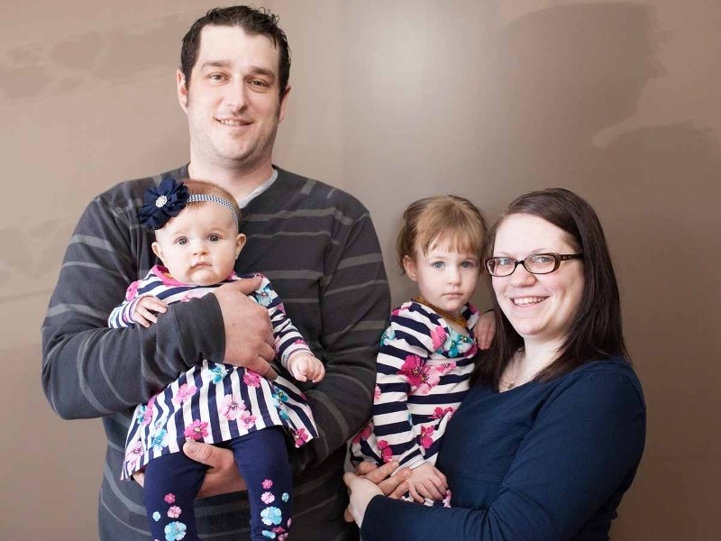 Dawn and Joel Kievits stand with their daughters Lila and Hollie.