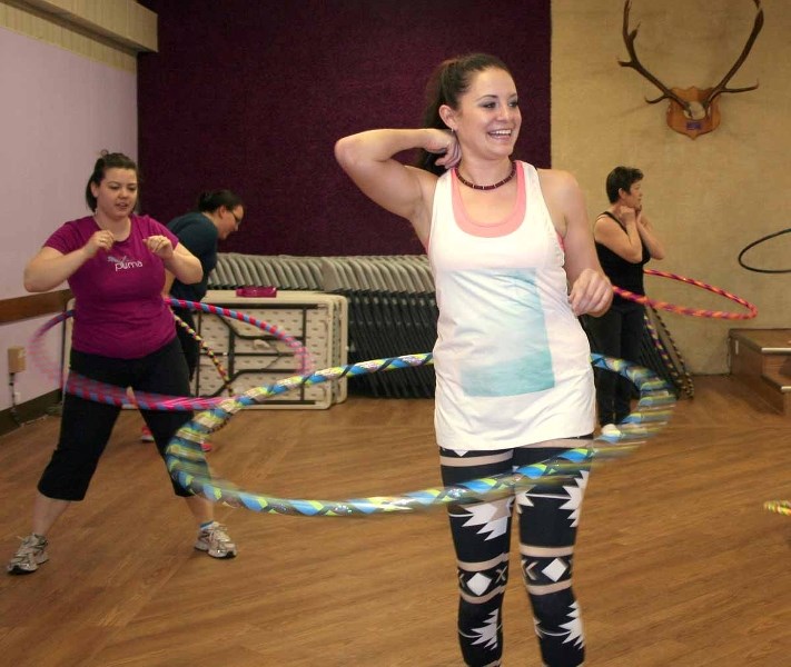 Christine Hanson, a hula hoop instructor who&#8217;s offering hooping classes in St. Paul, demontrates some moves for the people gathered at the March 16 class.