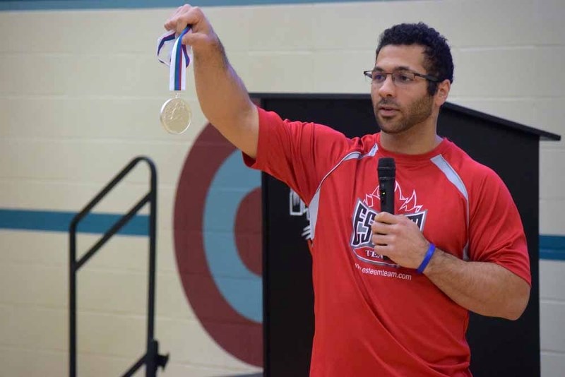 Kieran Block shows the students of Glen Avon School the medal he won while competing for Canada&#8217;s national sledge hockey team at the 2015 world championships.