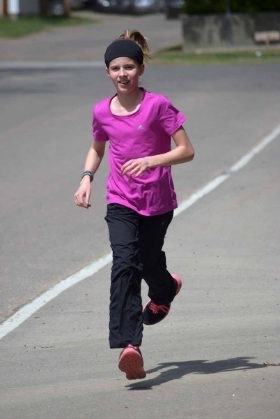 Avery Warawa tackled the last half of the 4.2 km Iron Horse Mini course for kids in Elk Point. She was the first kid to cross the finish line. She and her partner, Jadey