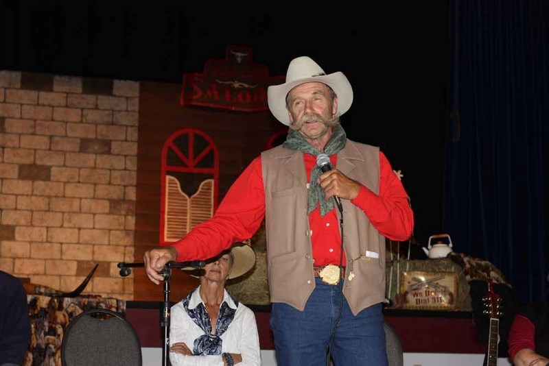 Bj Smith performs cowboy poetry at Friday night&#8217;s opening of the Vilna Cowboy&#8217;s Fest.
