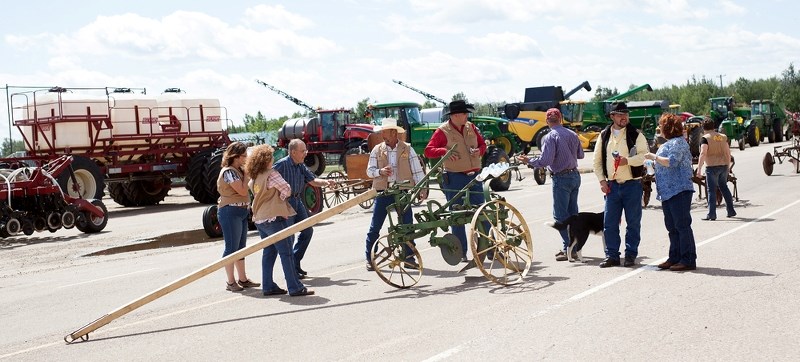 St. Paul Agriculture Society members and volunteers check out some of the equipment on display at the society&#8217;s 100th anniversary celebrations on Saturday afternoon.