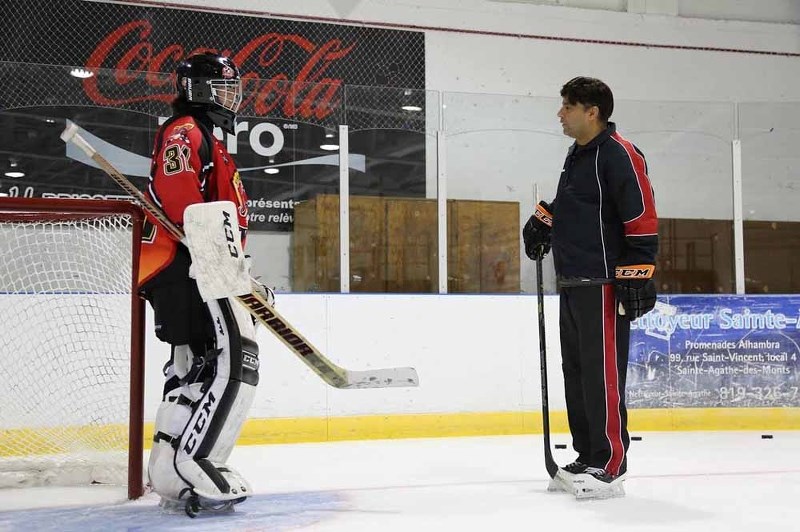 &#8216;Hit the Ice&#8217; goaltending instructor Sudsie Maharaj gives Davis Houle some pointers during a practice held during the two-week camp