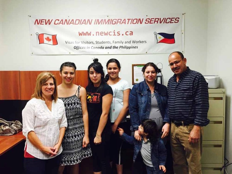 Christine Warkentin (first from left) stands with Lydia Mansouri (third from left), and the rest of her family at an open house at the New Canadian Immigration Services