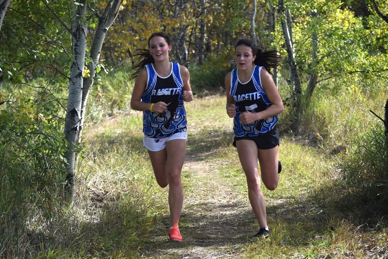 Racette School &#8216;A&#8217; Girls Cross Country runners Morgan Gerlinsky and Sydnie Bespalko wore smiles as they ran along the course at Ross Lake.