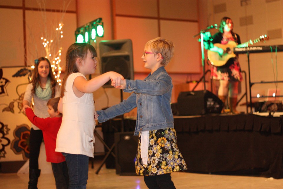 Adasyn Havener and Emery Brousseau dance the night away at the New Year&#8217;s Eve Family Benefit event, which took place on Dec. 31 at the St. Paul Recreation Centre.