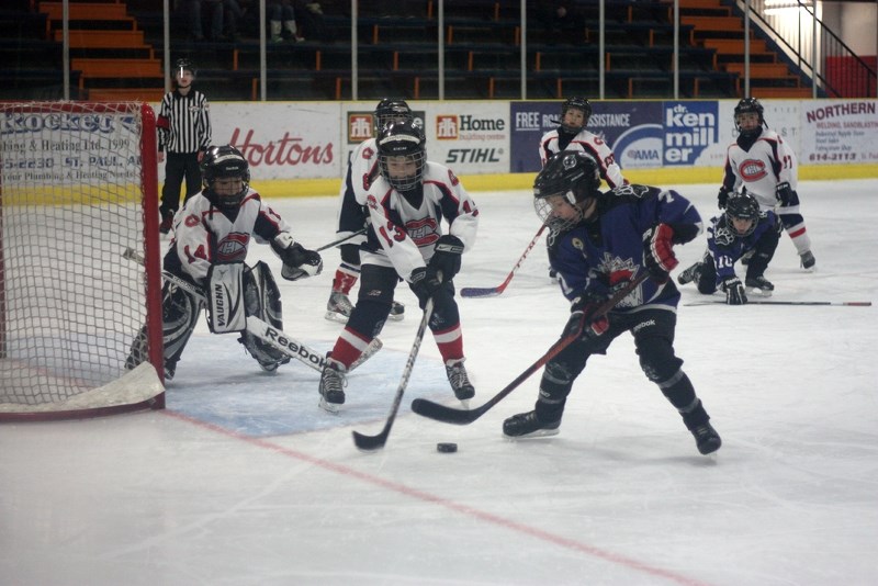 St. Paul Canadiens 2 goalie Ukiah Simons and Emmersyn Stybel work to defend the net from a Cold Lake Freeze attack during the St. Paul Novice hockey tournament this past