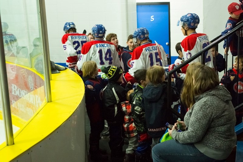 The St. Paul Canadiens exchange high fives with the kids gathered at Friday night&#8217;s home game last week. After a hard battle, the Canadiens would get edged out by the