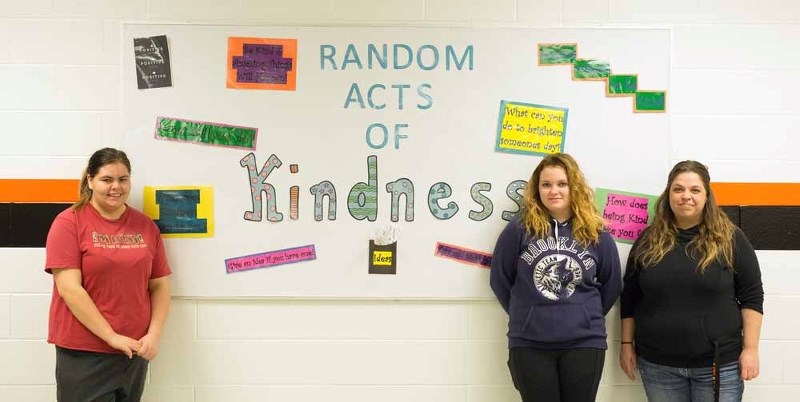 Liz Theroux, Karlie Schoff and Christy Schoneck stand in front of the Kindness Board at Regional High School. The students were busy spreading random acts of kindness last