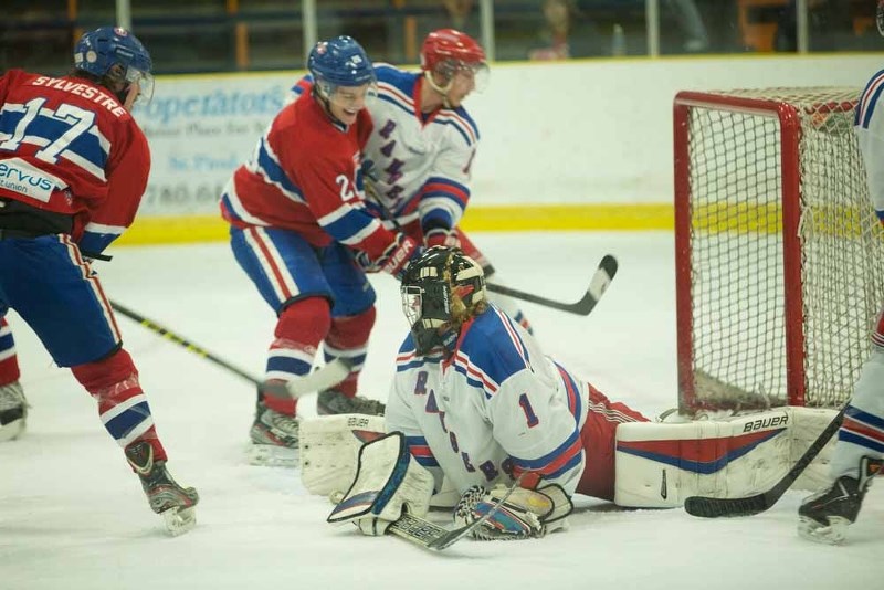Zach Sylvestre and Dyson Roy fight for the puck in front of the Rangers&#8217; net during the team&#8217;s Saturday night matchup. The Canadiens closed out their first round