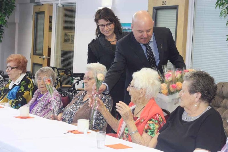 MLA Dave Hanson and his wife Donna hand out goodies to residents at Sunnyside Manor, last week. The lodge was celebrating 34 of its resident who are no 90 years or older.