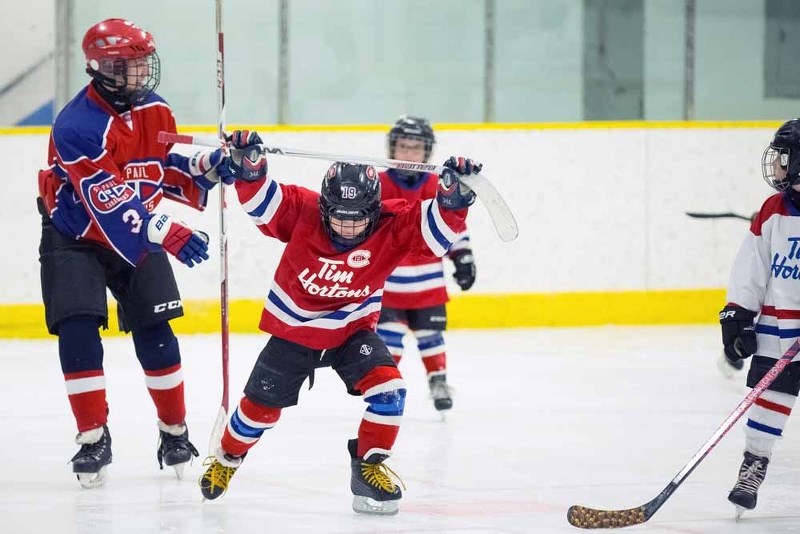 Cohen Roche celebrates a goal during the Timbits all-star game while midget Logan Hellquist looks on.