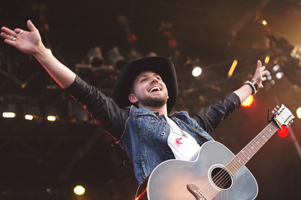 Flat Lake&#8217;s Brett Kissel takes the stage for his first song during the Hometown Homecoming concert at the Jaycee ballpark on Saturday night. The sold-out event drew in