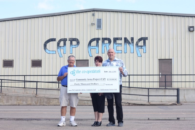 President of the CAP Arena Committee Ron Boisvert was happy to accept a $40,000 cheque from Sharmen and Shawn Saik, who own and operate Saik Insurance &#8211; The