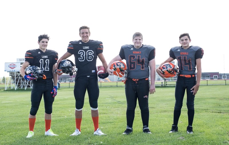 The St. Paul Lions and Bengals will hit the field this September in brand new uniforms and with upgraded helmets. Pictured is Christian Laramee, Brad Dubrule, Dawson
