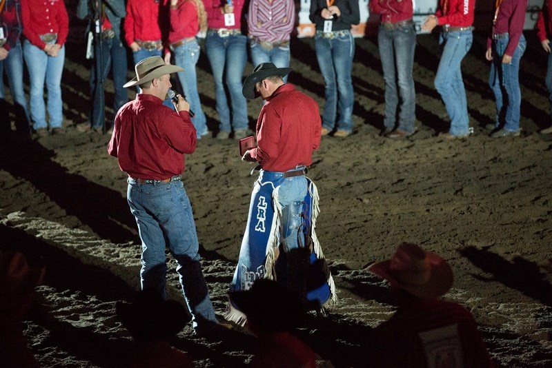 Tim Edge presents Lee Trach with the Cowboy of the Year buckle at this year&#8217;s Lakeland Rodeo Association Finals.