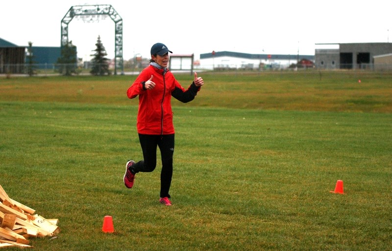 Janna Zarowny crosses the finish line at the Iron Horse Ultra race that took place through St. Paul and Elk Point areas last Saturday. She was part of a team made up of St.