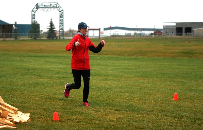 Janna Zarowny crosses the finish line at the Iron Horse Ultra race that took place through St. Paul and Elk Point areas last Saturday. She was part of a team made up of St.