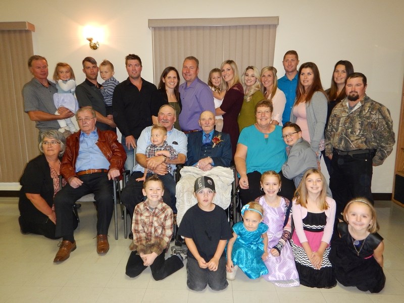 Mike Luciak (centre) celebrated his 100th birthday in Glendon with his family last week.