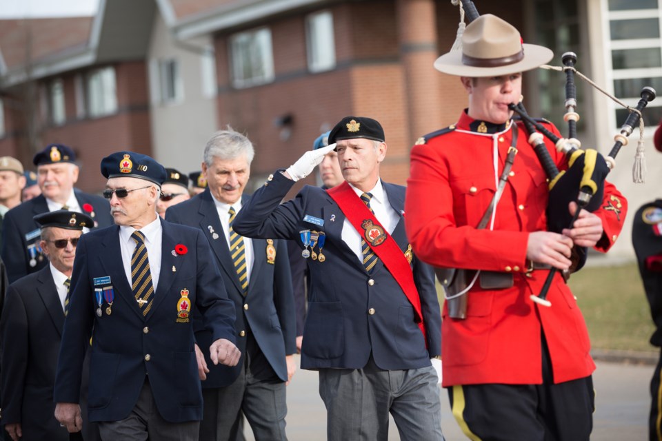 The St. Paul Legion&#8217;s John Yakimec salutes the cenotaph in St. Paul as he walks by with