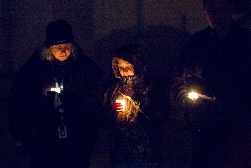 Shelly Amos and her son, Sawyer Amos-Slonowski, were among the people showing their support for the crisis association during a Thursday night candlelight vigil. Standing to