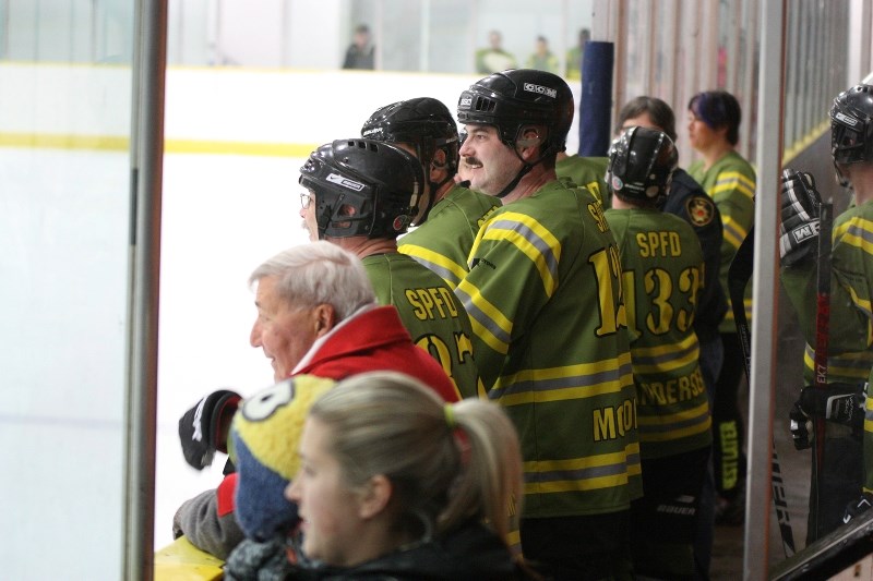 St. Paul Fire Department&#8217;s James McGonigal takes a break from playing to catch some of the hockey action last Thursday night, when the CFCW Critters and the St. Paul