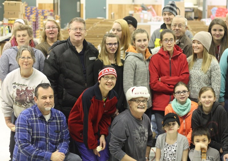 Dozens of volunteers gathered over the weekend to package and distribute Christmas hampers and gifts to families in need of a little extra support this year.