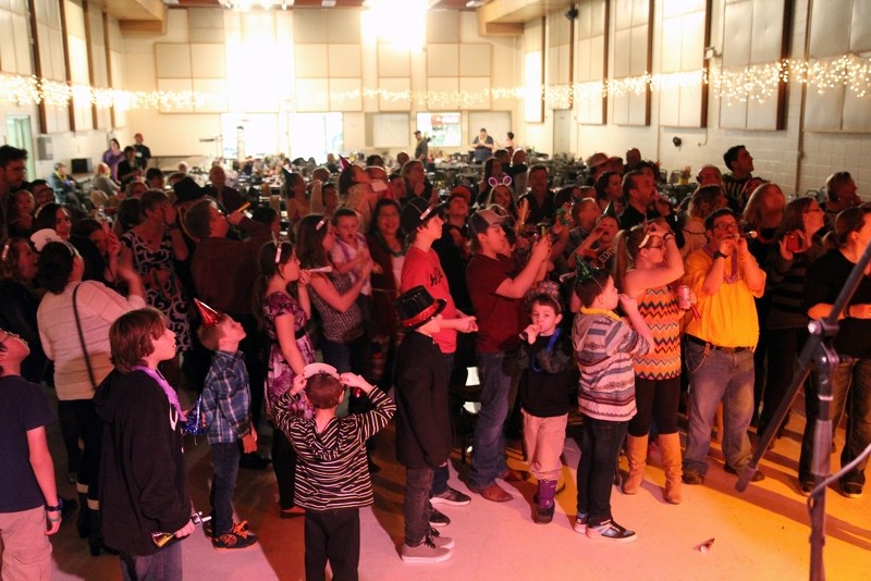 A crowd gathers to celebrate the arrival of 2017 during he St. Paul &#038; Community Family Benefit dance, on New Year&#8217;s Eve.