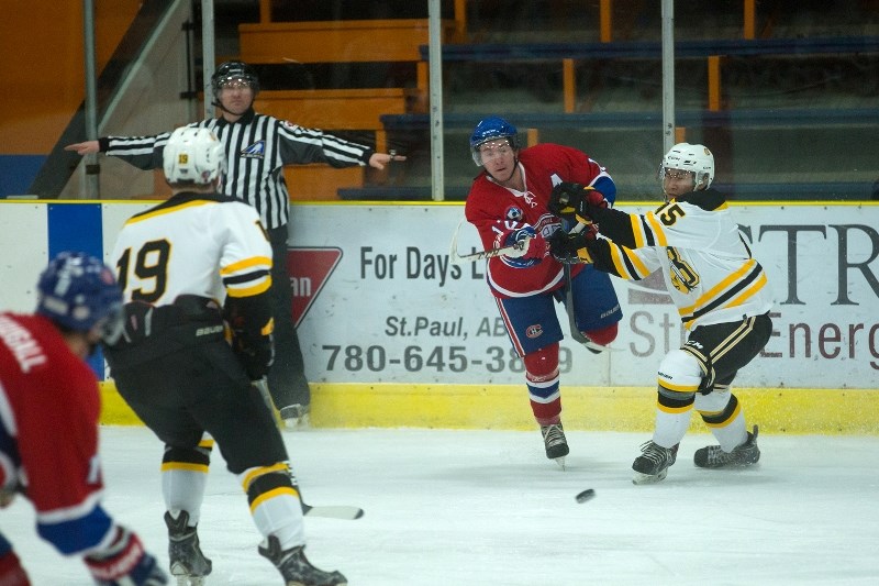 Assistant captain of the Canadiens Ryley Wozniak battles for the puck in the team&#8217;s game against the Onion Lake Border Chiefs, with the Canadiens coming away with a 2