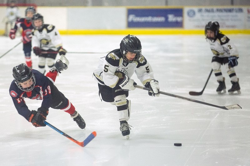 Ryan Balmer flies through the air to try to get the puck from a Bonnyville player at St. Paul Novice 1&#8217;s home tournament. The team came away with a second place finish.