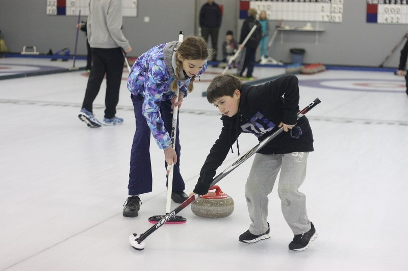 Mila Boisvert and Elijah Dean were among the dozens of junior curlers that took the ice during Sunday&#8217;s annual junior curling bonspiel.