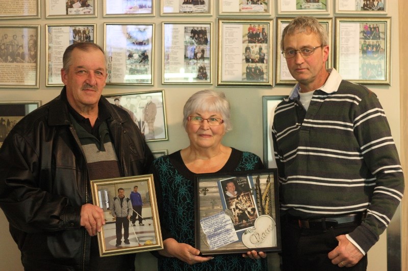 Aime and Yvonne St. Arnault presented a picture of their son Richard, who passed away last year, to Mallaig curling club president Marc Michaud. The picture of Richard will