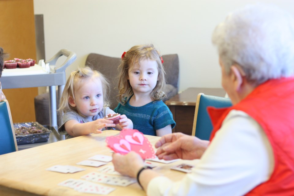 Daphne Lock and Georgia Newby were among the kids with Parent Link that delivered cupcakes and Valentine&#8217;s cards to the seniors at Sunnyside Manor on Feb. 14, as many