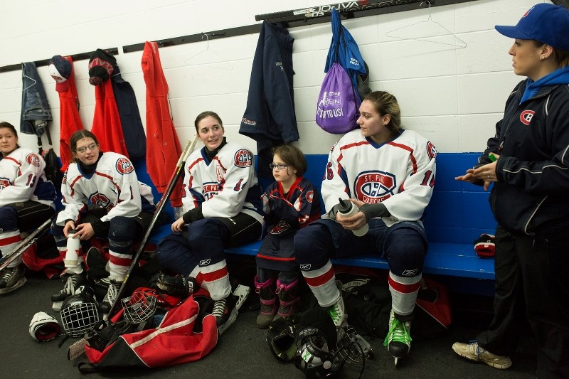 Dominique Bernier (right), coach for the St. Paul Xtreme Oilfield Midget girls&#8217; hockey team, shares a talk in the locker room with those gathered for Girls Hockey Day