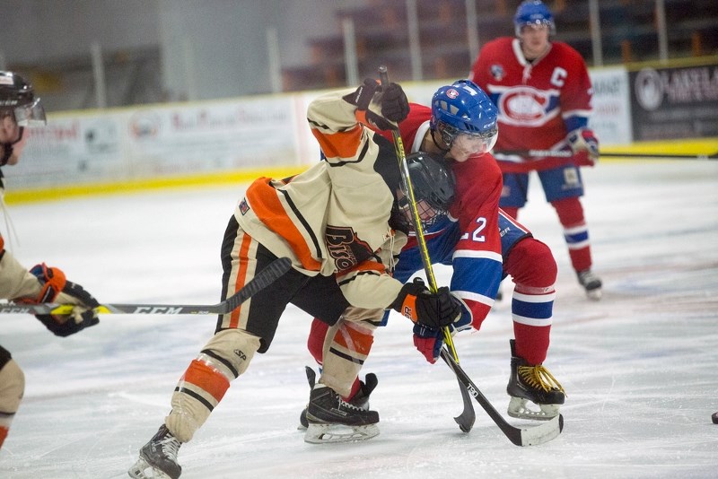 Kona Jackson battles for the puck against a Wainwright player on Thursday night. Jackson scored both of St. Paul&#8217;s goals.