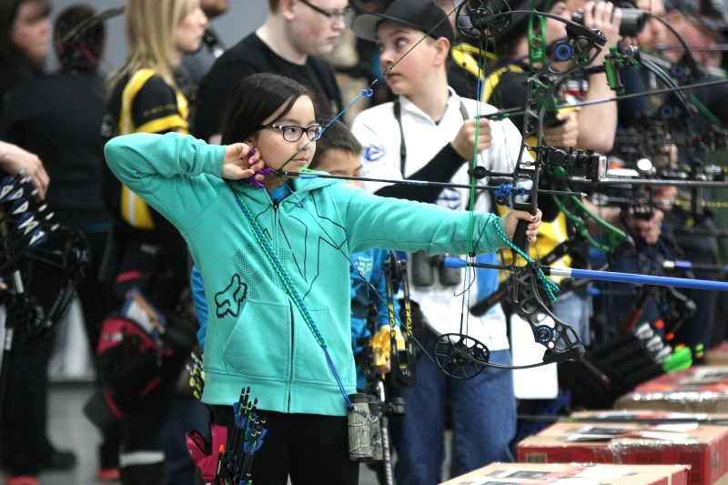 Naja VanBrabant takes aim during the Indoor 3-D Archery Shoot, held over the weekend. She received a second place finish in the Pre-Cubs category on Saturday and Sunday.