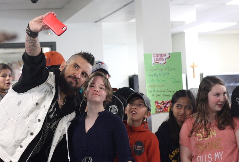 Musician Robb Nash was in St. Paul, Ashmont and Elk Point schools last week giving presentations aimed at suicide prevention, with students like Brianna Demoissac getting