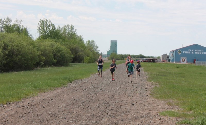 Kurt Poulin and Liam Michaud lead a pack of runners to the finish line of the Athletic Alley Iron Horse Mini on May 27. The young runners formed a team of their own to raise