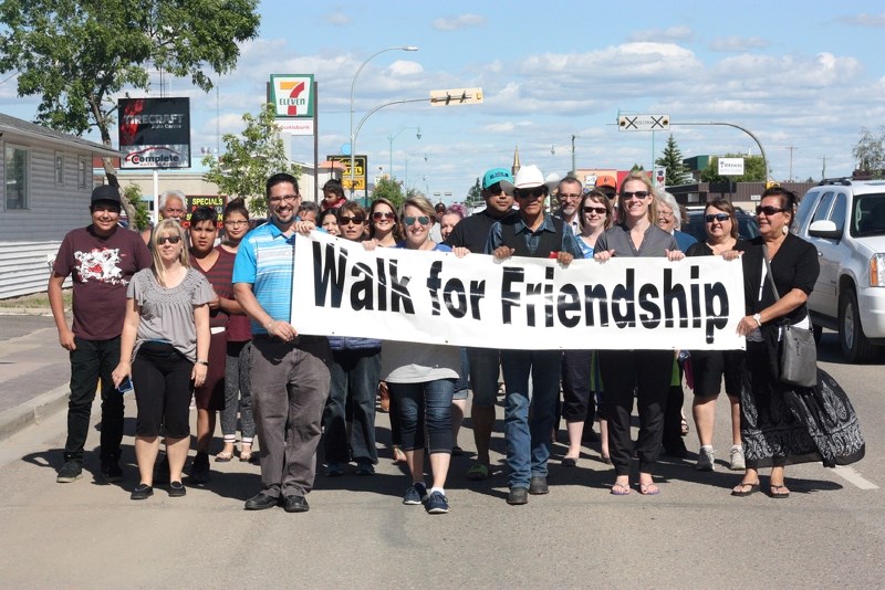 Participants in the Walk for Friendship make their way down St. Paul&#8217;s main street as part of Reconciliation-St. Paul activities last week.