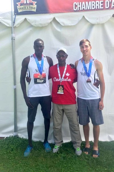Matthew Hawiuk (right) poses alongside a coach and fellow athlete from the Voleo track and field club. Hawiuk is a recent St. Paul Regional High School graduate. He received