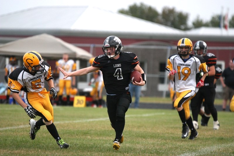 Parker Lumby stiff arms a defensive lineman as he charges down the field in the Lions&#8217; home opening game, which the team won, 32-14.