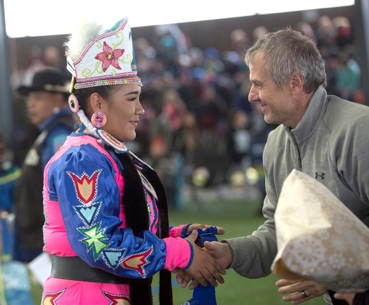 SPERD superintendent Glen Brodziak congratulates senior powwow princess Hailey Steinhauer Salopree.