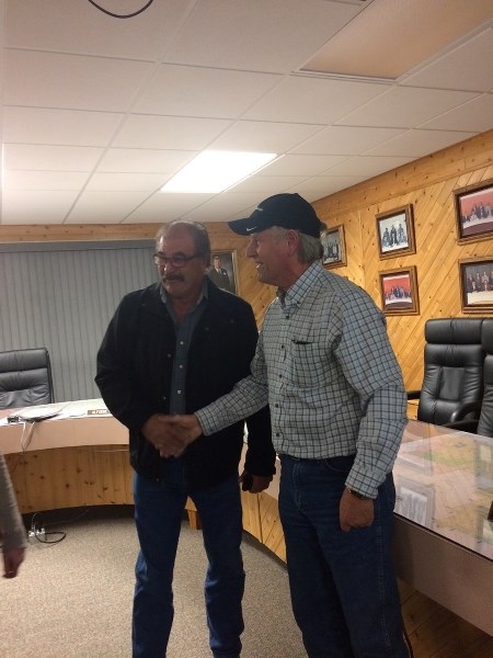 County of St. Paul Reeve Steve Upham and incumbent councillor Cliff Martin congratulate each other on their respective wins, when results came in on Oct. 16 at the County of