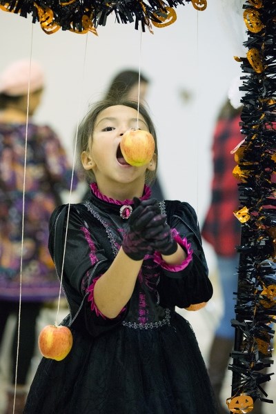 A child enjoys bobbing for apples at last year&#8217;s Blue Quills Halloween event. This year&#8217;s event will take place on Oct. 26
