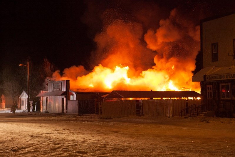 Firefighters battle the flames at Porky&#8217;s Bar &#038; Grill on Saturday morning.