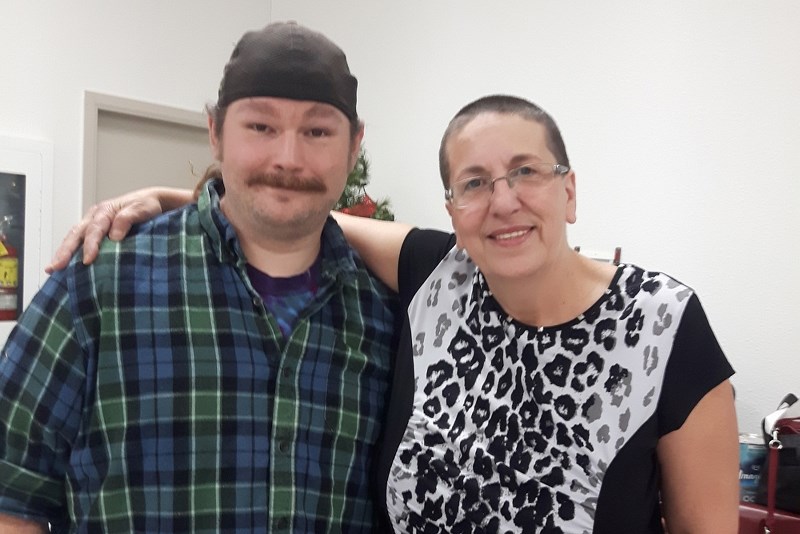 Josiah Clarke (left) is the new manager of the St. Paul Animal Shelter. He recently shaved his beard, while Anna Leskiw (right) shaved her head, as a fundraiser for the
