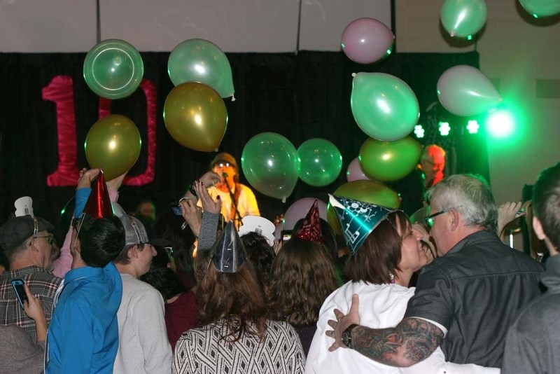 Balloons fall as 2018 is welcomed during the New Year&#8217;s Eve Family Benefit dance.