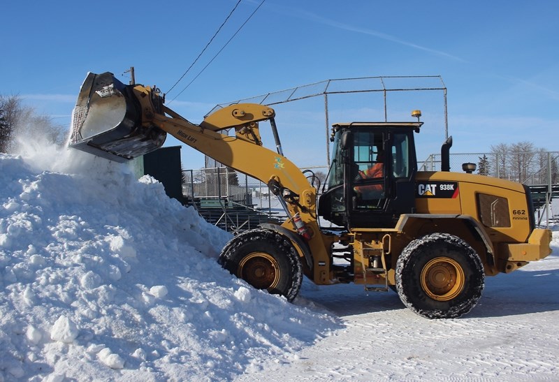 A Cat dozer clears snow away from the Pow Wow Grounds on March 8 in preparation for the Rubber Boot Sno Pitch Tournament over the weekend. Lac La Biche County council