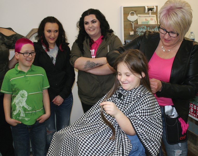 Six-year-old Charlize Braund gets her hair cut by Deborah Gauthier at the Chic Beautique in Plamondon on March 17. Charlize was donating 10 inches of her hair to use for wigs 
