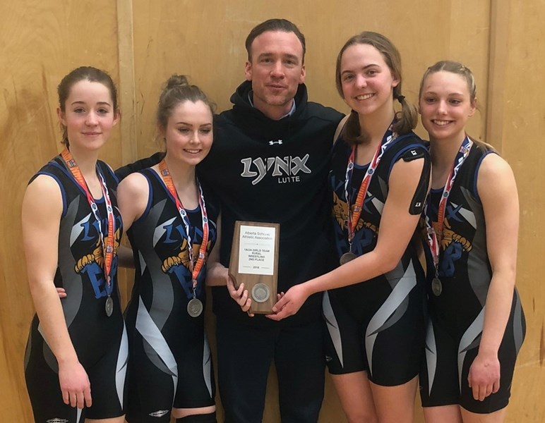 Sierra Cloutier, Holly Dulmage, coach Darcy Plamondon, Emilee Gauthier and Jenae Gauthier pose after all four wrestlers won silver medals at the Rural Wrestling Provincials